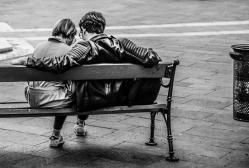 Canva grayscale photo of two person sitting on a bench
